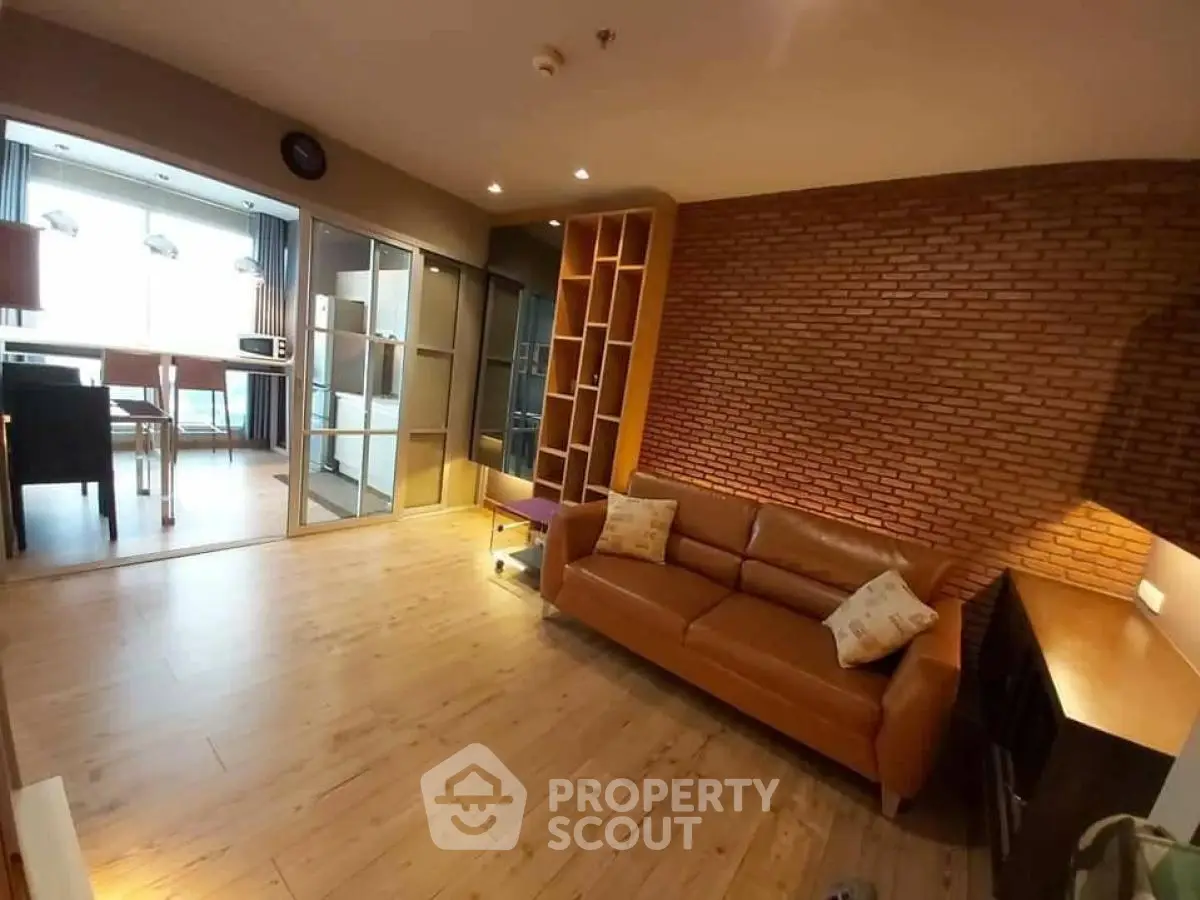 Spacious living room with brick accent wall and modern furnishings