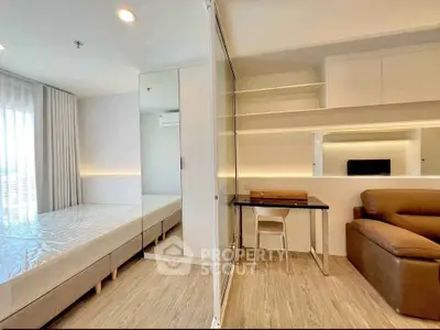 Modern studio apartment with cozy living area and sleek furnishings