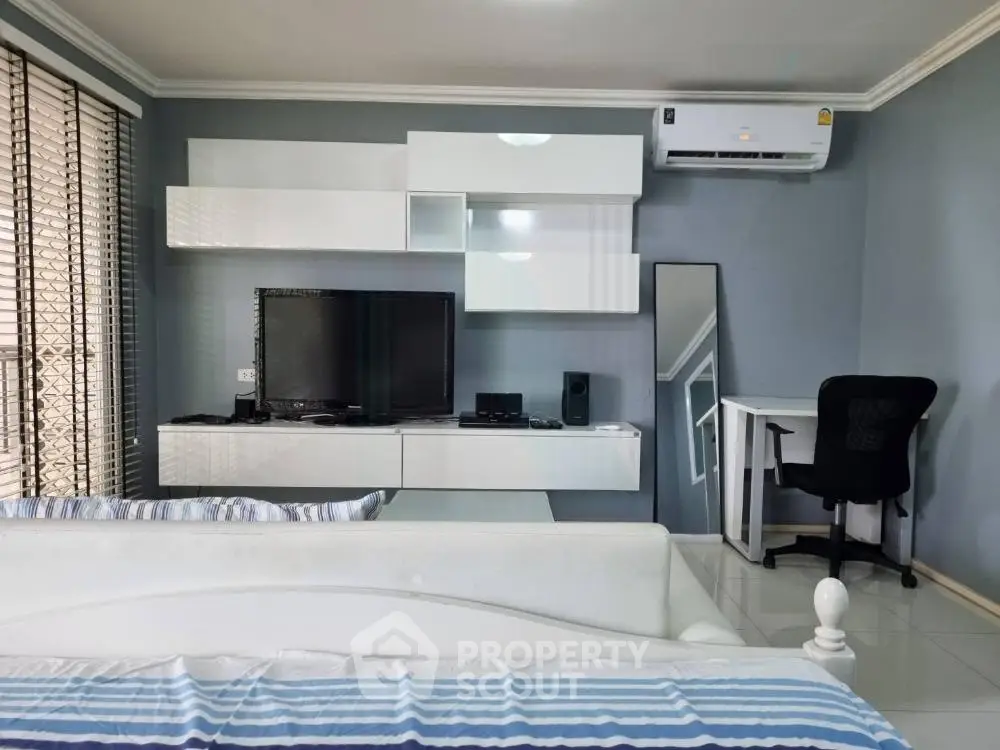 Modern living room with sleek furniture, air conditioning, and stylish decor
