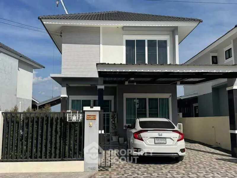 Modern two-story house with carport and sleek exterior design