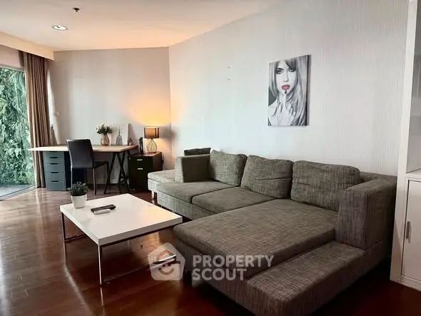 Modern living room with stylish gray sofa and chic decor in a cozy apartment setting.