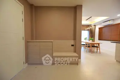 Modern interior with dining area and minimalist design, featuring neutral tones and sleek furniture.