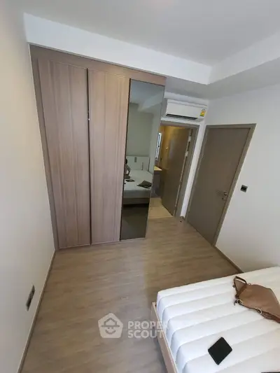 Modern bedroom with sleek wooden wardrobe and minimalist design