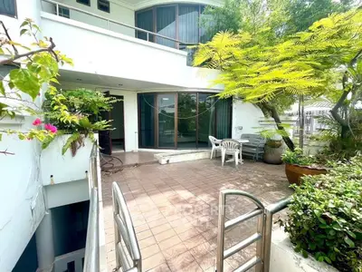 Spacious balcony with lush greenery and modern design, perfect for relaxation and outdoor gatherings.