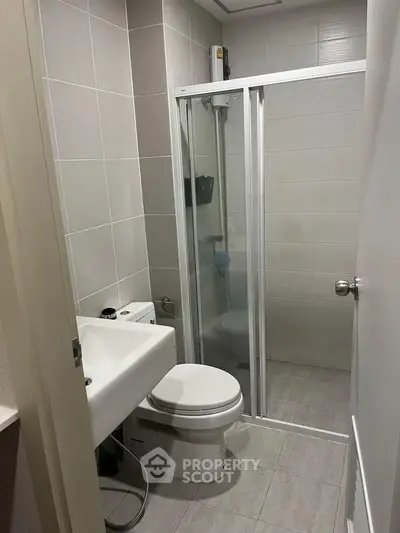 Modern bathroom with sleek shower enclosure and contemporary fixtures.