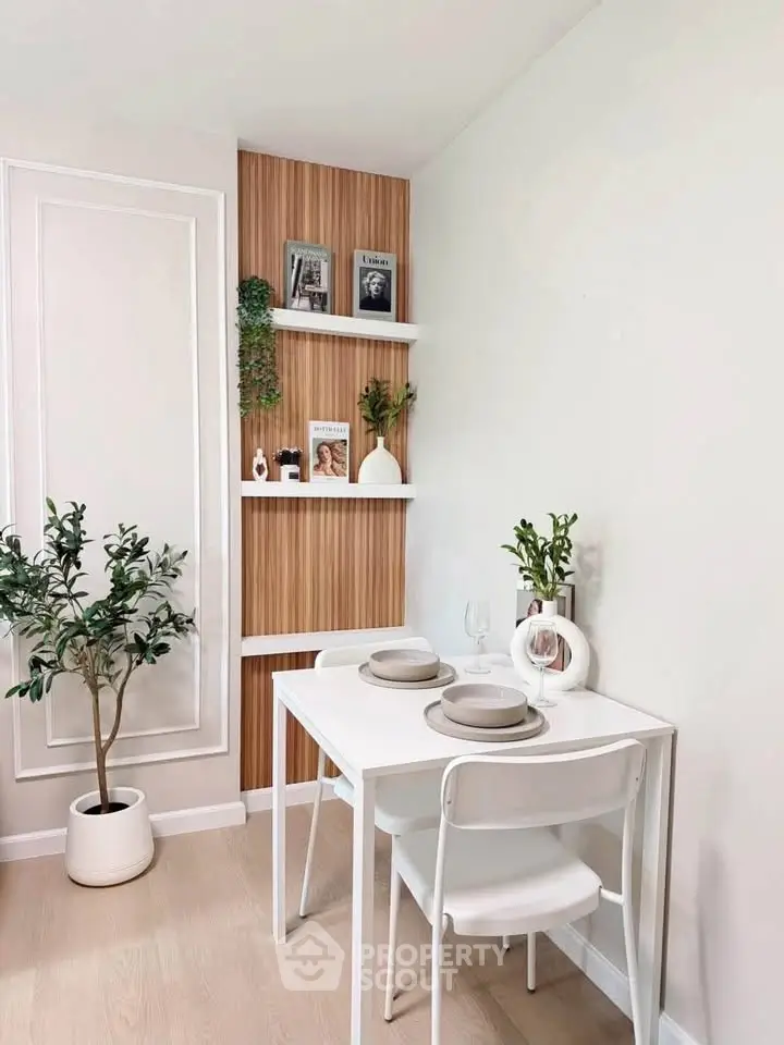 Chic dining nook with modern decor and elegant shelving in a cozy apartment setting.