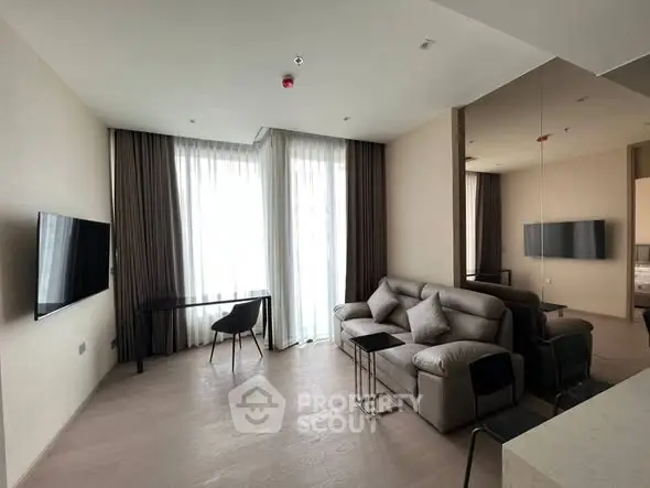 Modern living room with sleek furniture and large windows for natural light