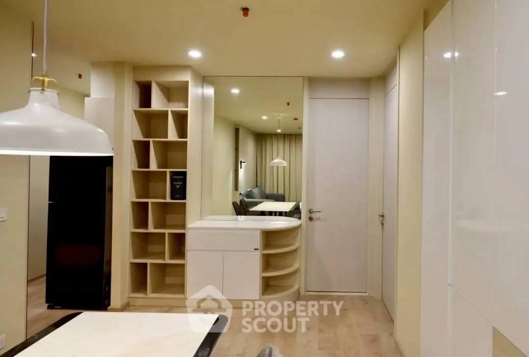 Modern interior with sleek storage and elegant lighting in a stylish apartment.