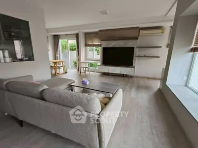 Spacious modern living room with large TV and stylish furniture