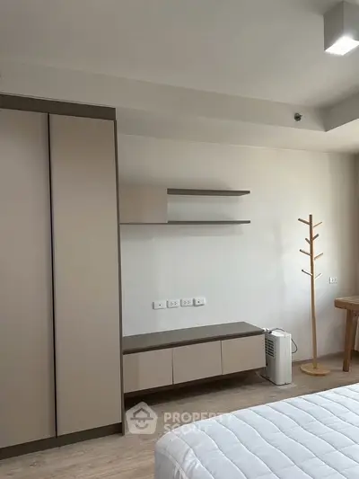 Modern bedroom with minimalist furniture and neutral tones