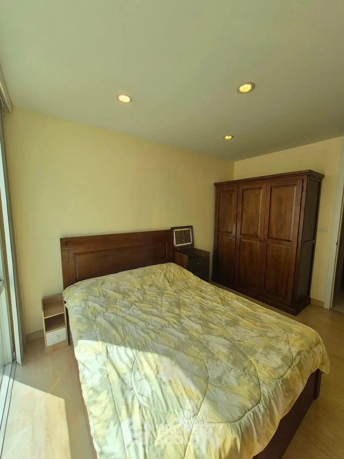 Cozy bedroom with wooden furniture and ample natural light