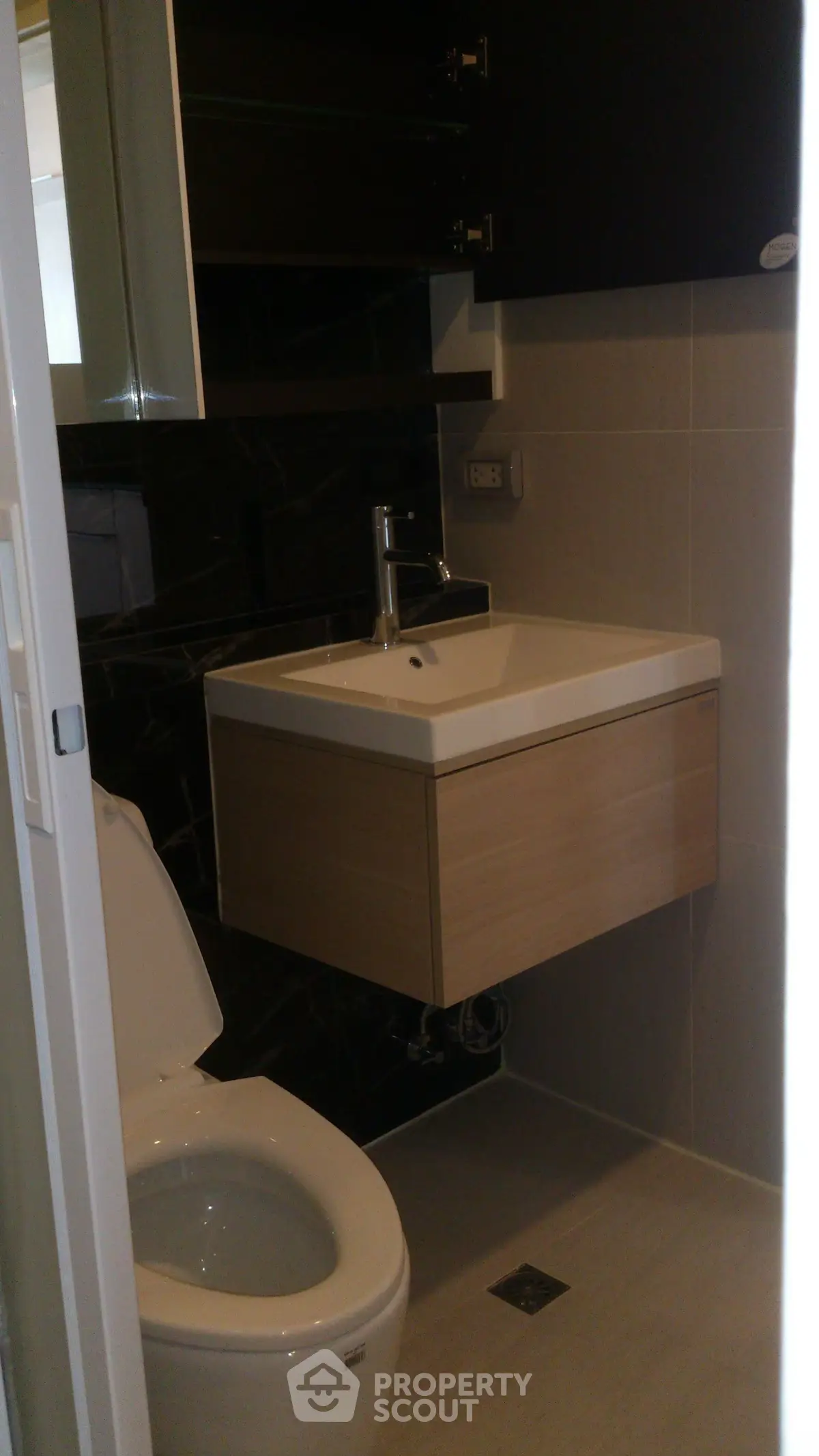 Modern compact bathroom with sleek fixtures and contemporary design.