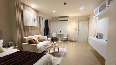 Modern living room with cozy sofa, stylish decor, and elegant lighting