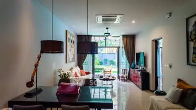 Spacious modern living room with garden view, elegant decor, and ample natural light.