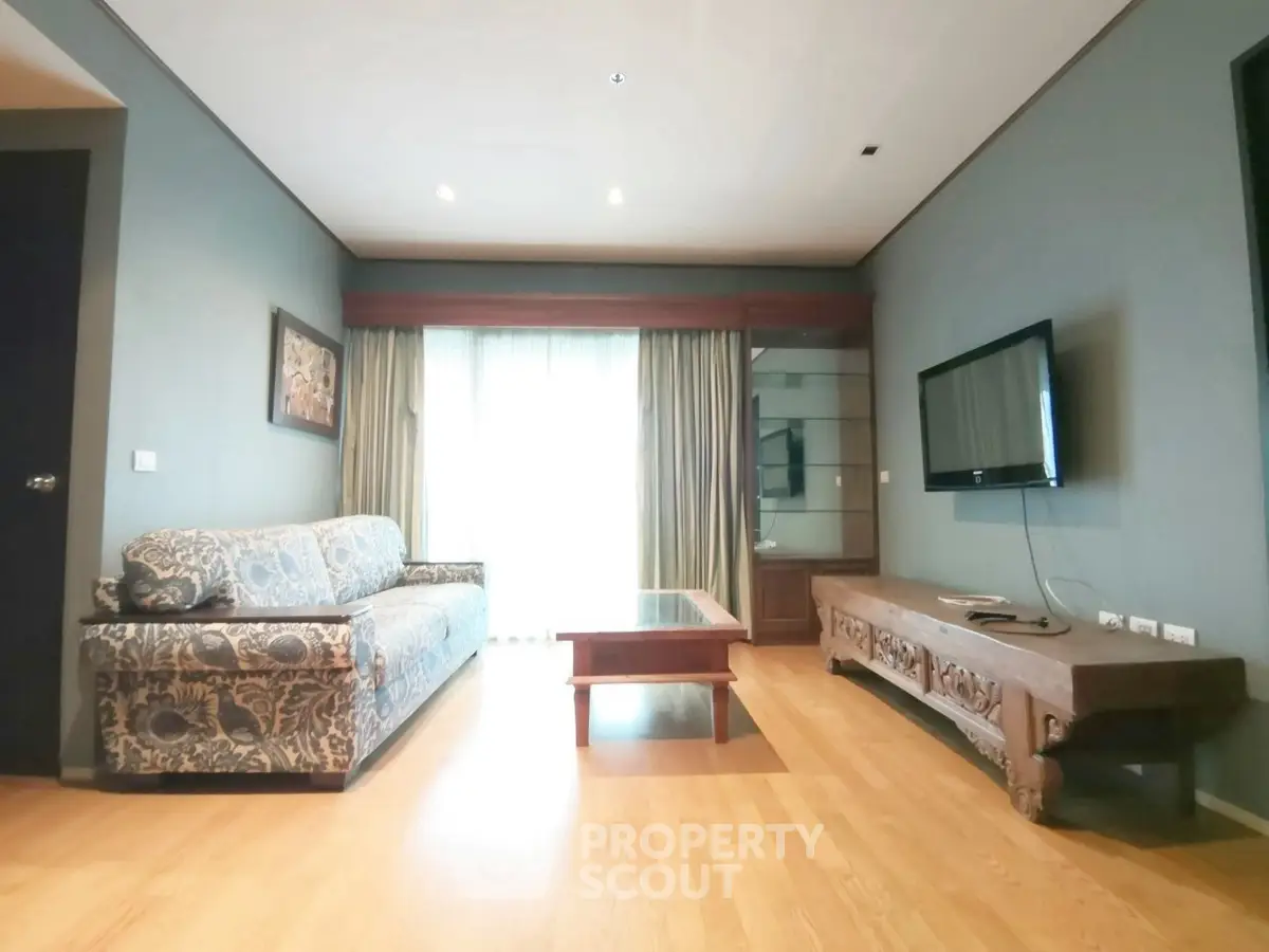 Spacious living room with elegant decor and large window for natural light