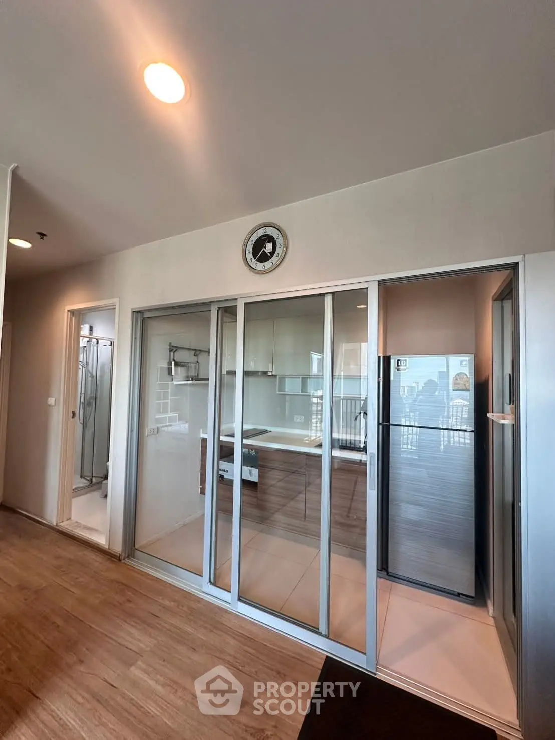 Modern interior with sliding glass doors and wooden flooring, showcasing a sleek and contemporary design.