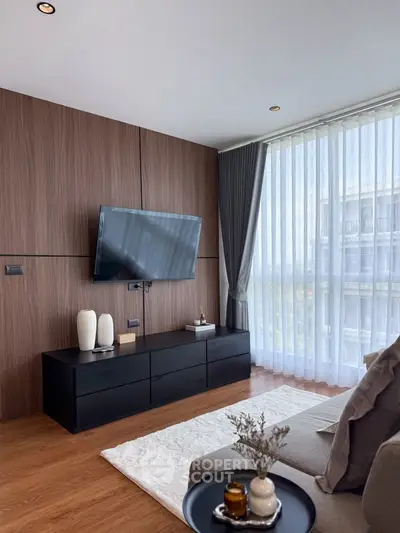Modern living room with large window and stylish decor