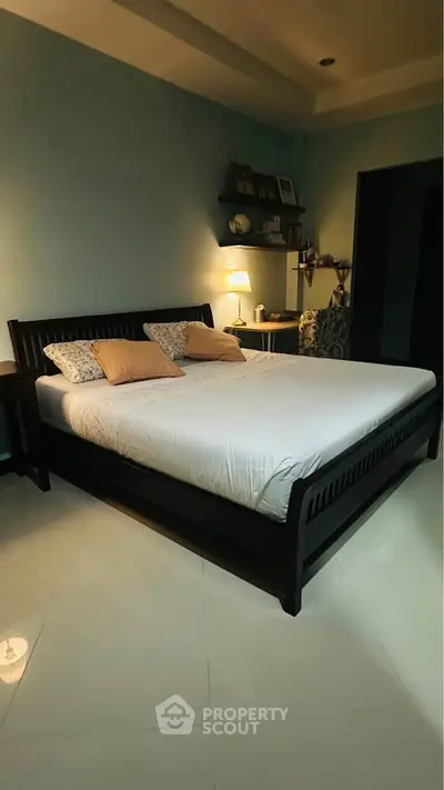 Cozy bedroom with elegant bed and soft lighting, perfect for relaxation and comfort.