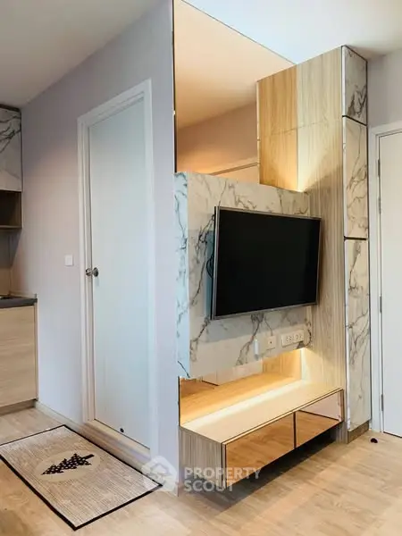 Modern living room with sleek TV setup and marble accents