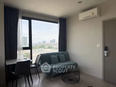 Modern living room with city view, featuring a sleek sofa, stylish table, and air conditioning.
