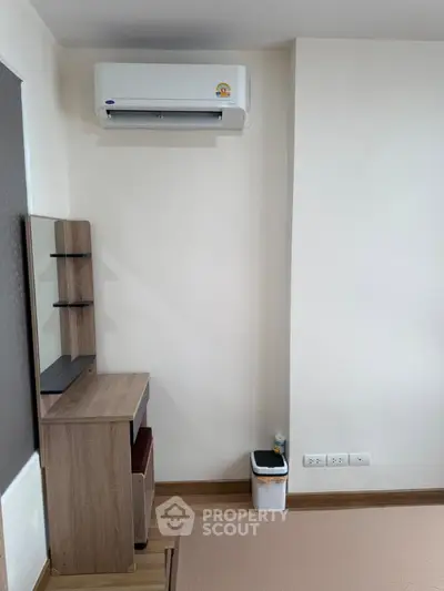Modern bedroom with air conditioning and wooden furniture, perfect for comfort and style.