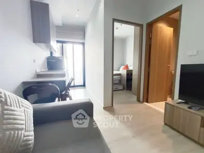 Modern apartment interior with cozy living area and compact kitchen, featuring a bright bedroom and stylish decor.