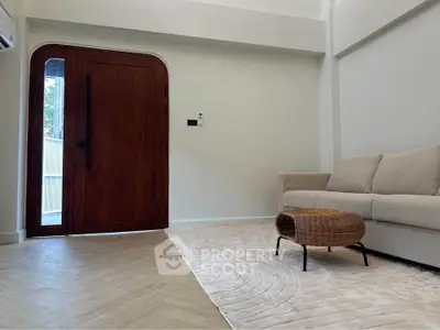 Modern living room with elegant wooden door and cozy beige sofa