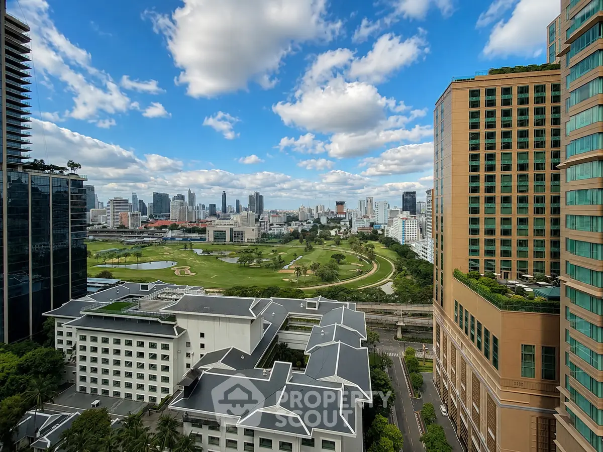 Stunning cityscape view from high-rise building overlooking lush green park and skyline.