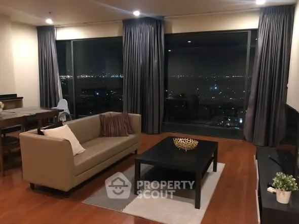 Spacious living room with city view, modern furniture, and elegant decor.
