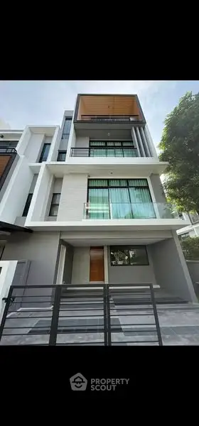 Modern multi-story residential building with sleek design and large windows