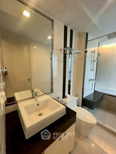 Modern bathroom with sleek fixtures and glass shower enclosure