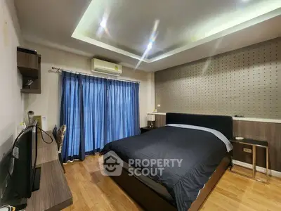 Spacious modern bedroom with stylish decor and natural light