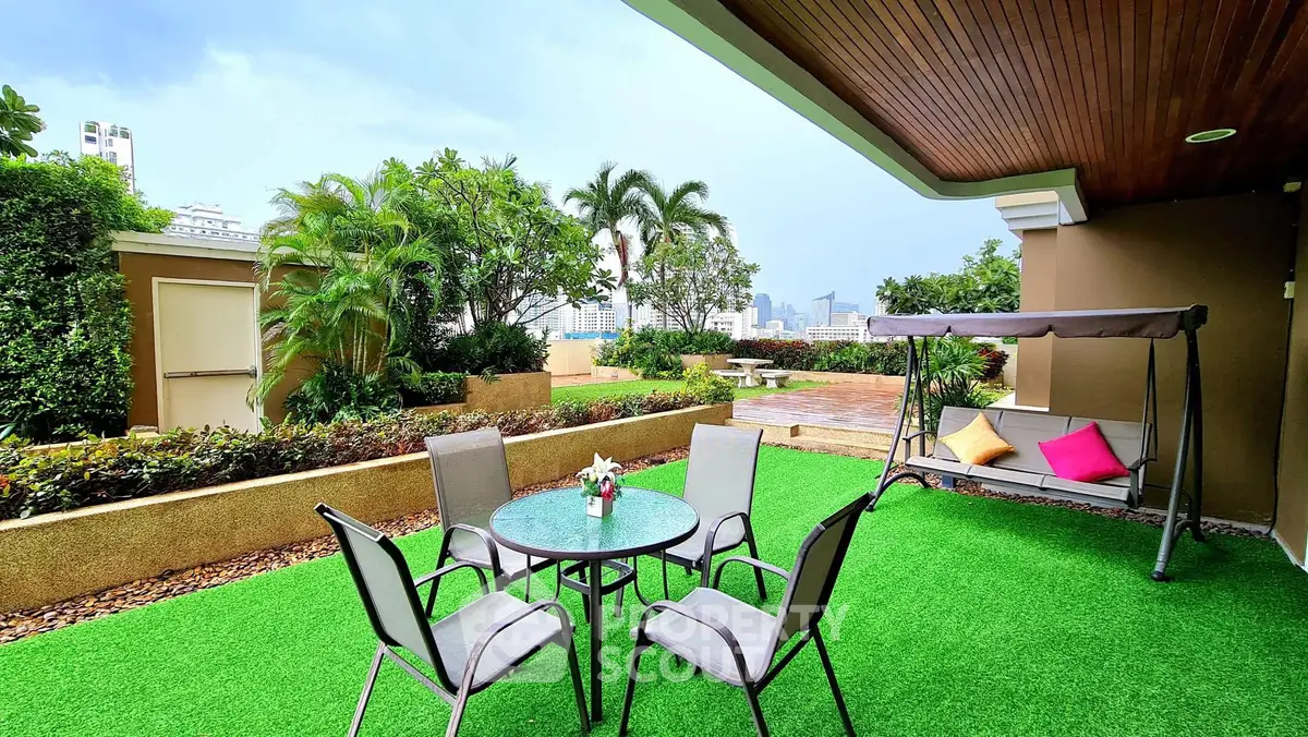 Spacious rooftop garden with seating area and city view, perfect for relaxation.