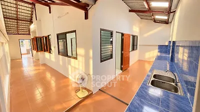 Spacious open-layout kitchen with blue countertops and ample natural light.
