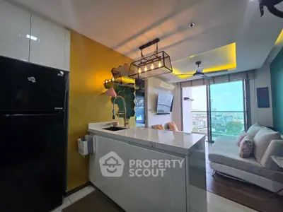 Modern open-layout kitchen and living room with stylish lighting and city view.