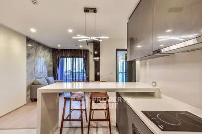 Modern open-plan kitchen and living room with sleek design and stylish lighting