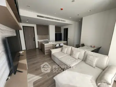 Modern living room with open kitchen layout and stylish furniture