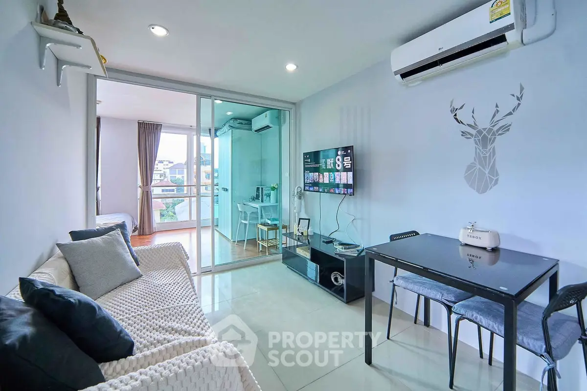 Modern living room with balcony, stylish decor, and air conditioning in a cozy apartment.