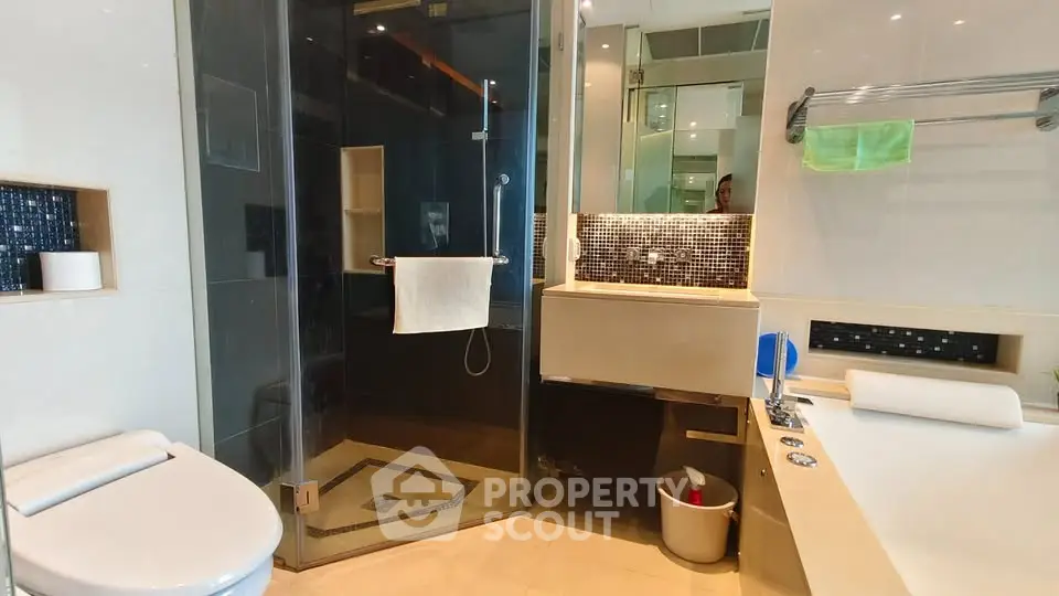 Luxurious modern bathroom with glass shower and elegant fixtures