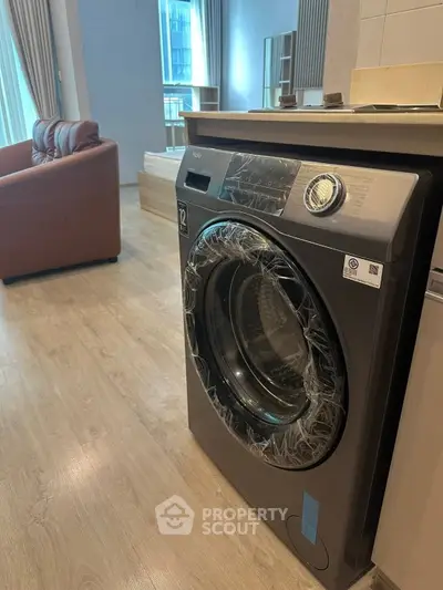 Modern apartment interior with washing machine and cozy living area