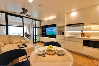 Modern open-plan living room and kitchen with sleek design and city view.