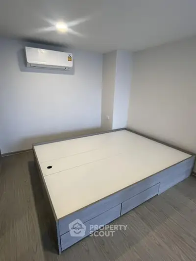 Modern minimalist bedroom with built-in storage and air conditioning