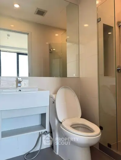 Modern bathroom with sleek fixtures and glass shower enclosure