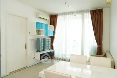 Modern living room with sleek furniture and large window for natural light.