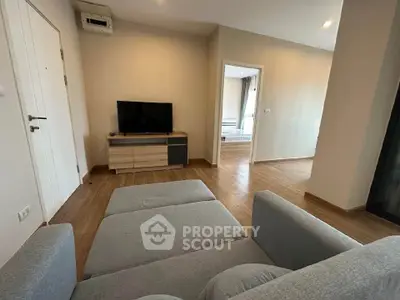 Spacious living room with modern furniture and wooden flooring