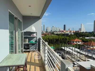 Spacious balcony with city skyline view, perfect for relaxation and enjoying urban living.