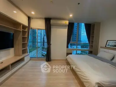 Modern bedroom with large windows and balcony in a high-rise apartment
