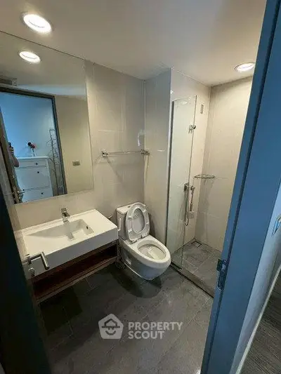 Modern bathroom with sleek fixtures and glass shower enclosure