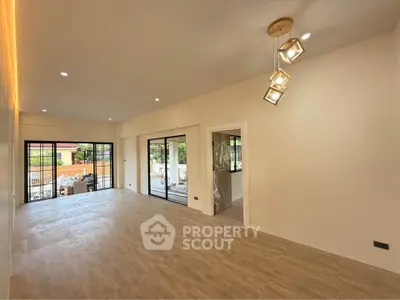 Spacious modern living room with elegant lighting and large windows