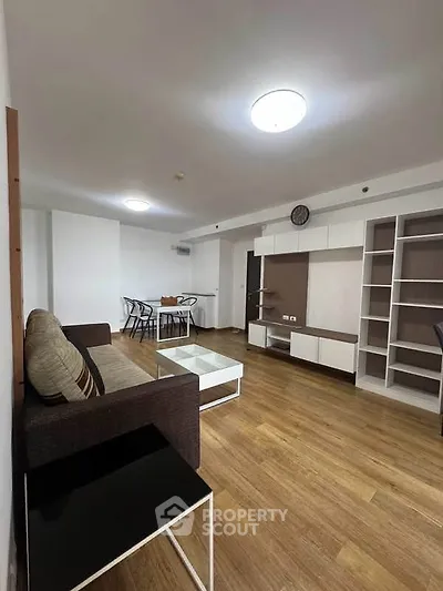 Spacious modern living room with wooden flooring and stylish furniture